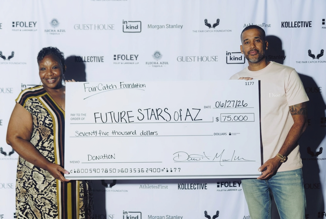 David and Chondra Mulugheta presenting a $75,000 grant check from The Fair Catch Foundation to Future Stars of AZ.